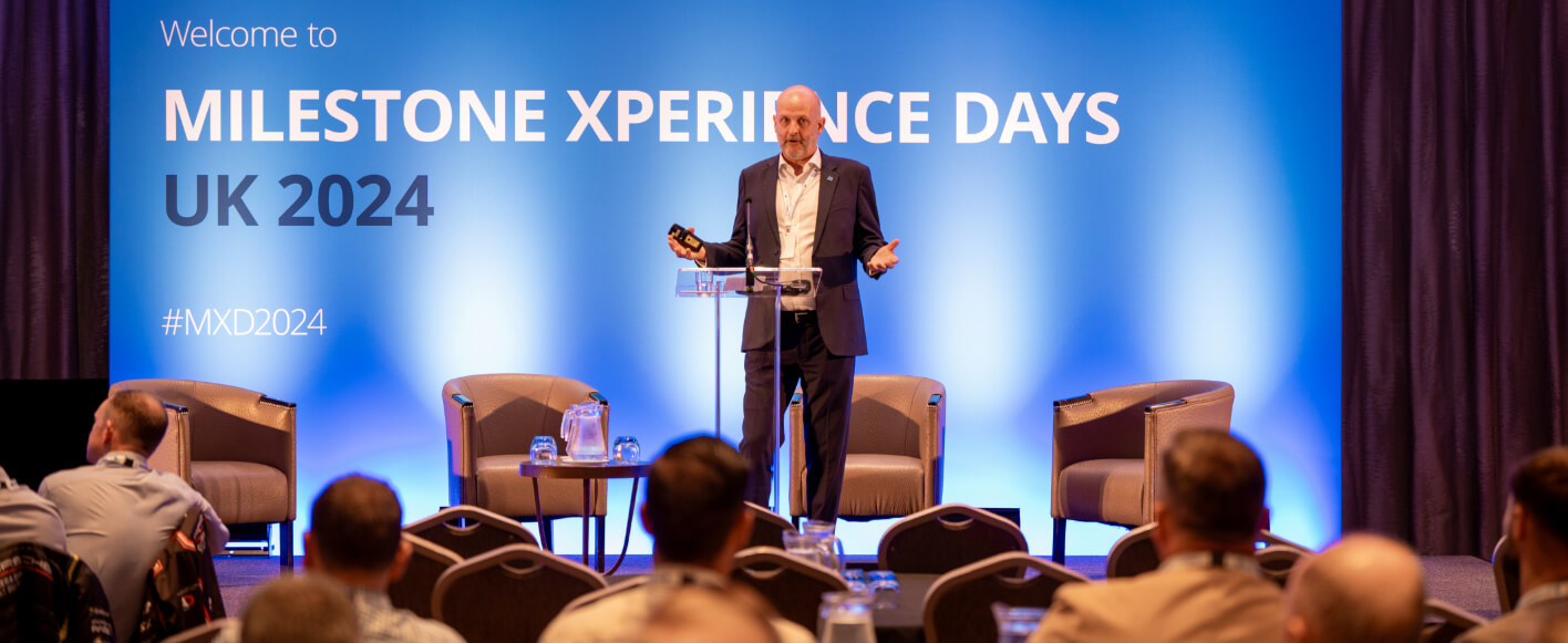 Henley Milestone - Man on stage giving presentation